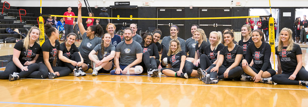 Adapted Athletics Supporters sitting on gym floor for group photo