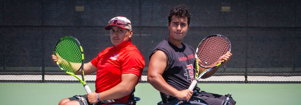 Two tennis players in wheelchairs posing with tennis racquets
