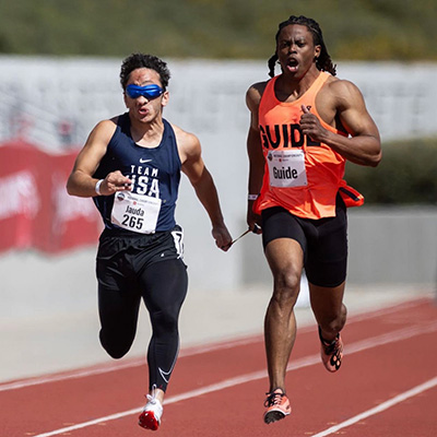 Humoody Smith and his guide running in the 2024 Paralympic Track and Field Championships.