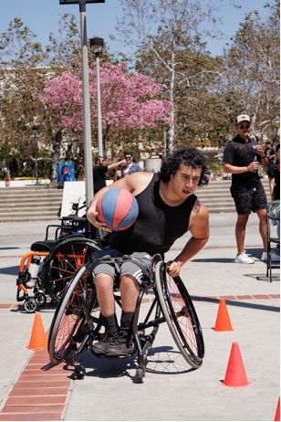 A para-athlete weaving through a series of cones.