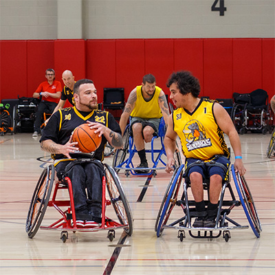 Wheelchair Basketball Athletes compete to score.
