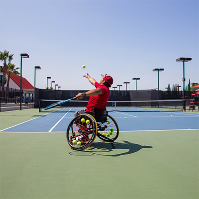 Manny Gomez preparing to serve a ball.