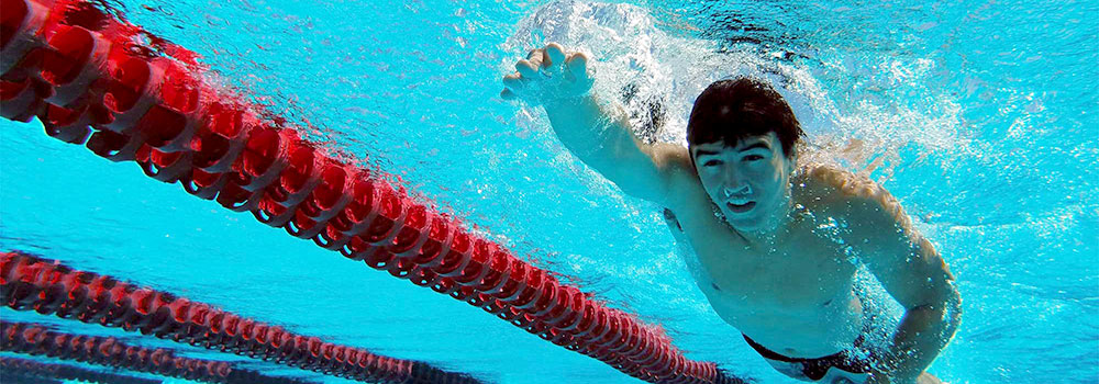 Young Man Swimming Laps