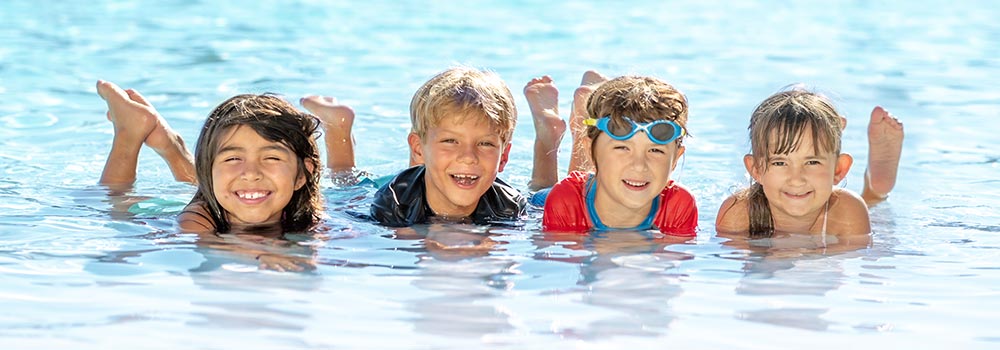 Four kids having fun in lounge pool