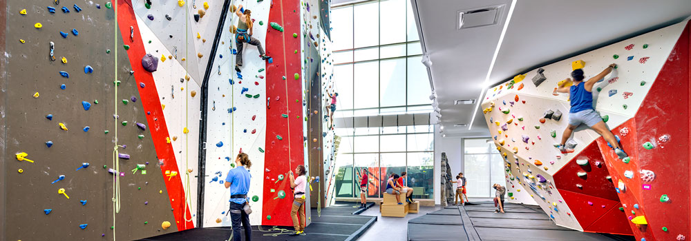 Students practicing indoor rock climbing at the ARC