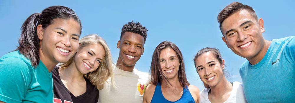 Group of students in athletic gear smiling