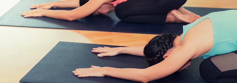 Women doing yoga on yoga mats
