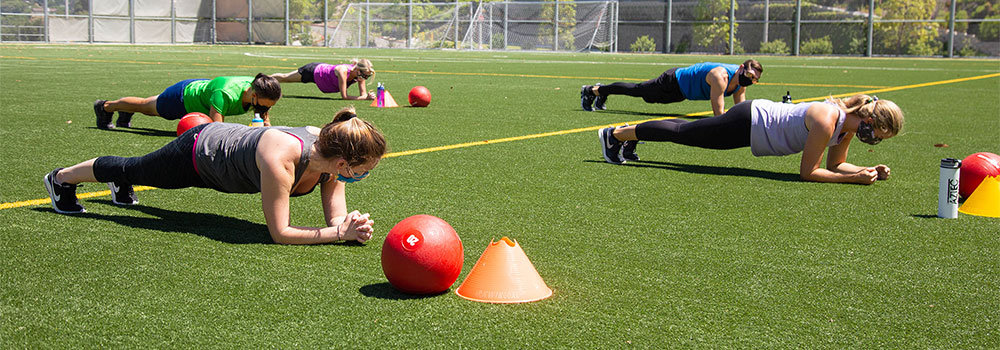 Group Fitness Plank workout on the field