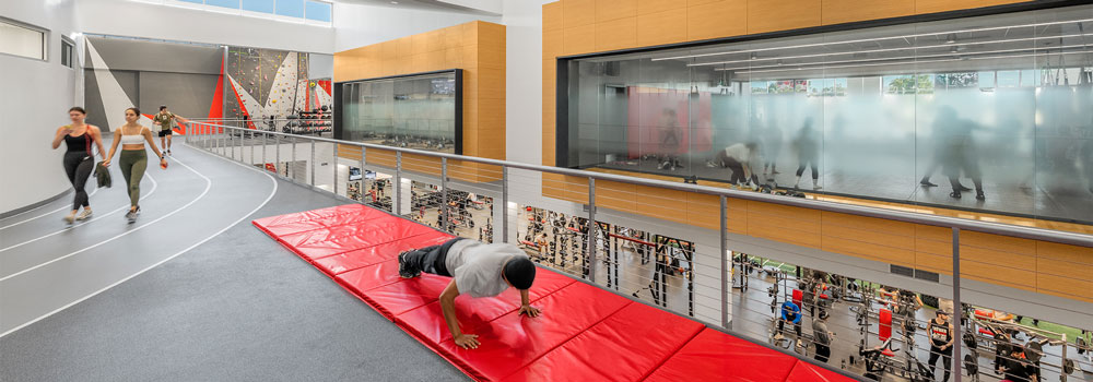 ARC second floor - students walking the track and student doing pushups on a mat