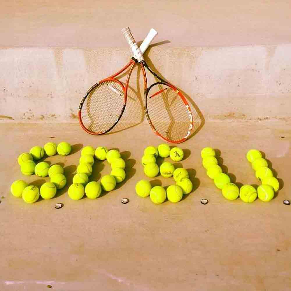 Tennis balls making SDSU and two tennis raquets 