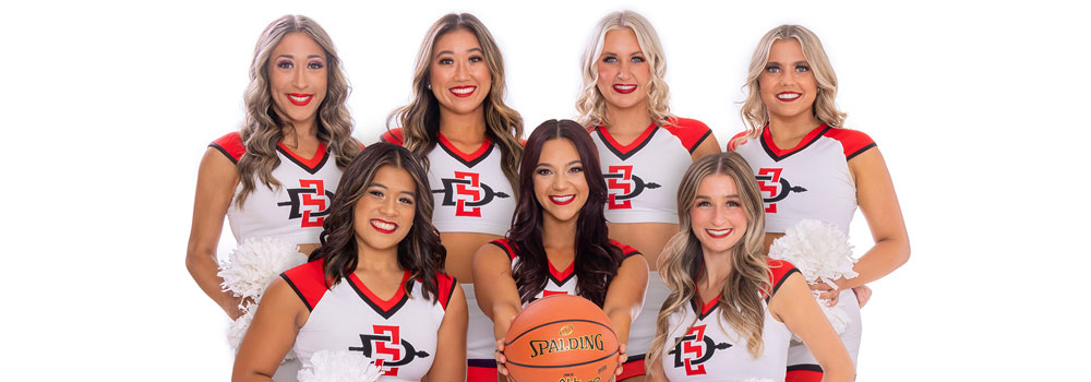 Dance Team members with center member holding a basketball