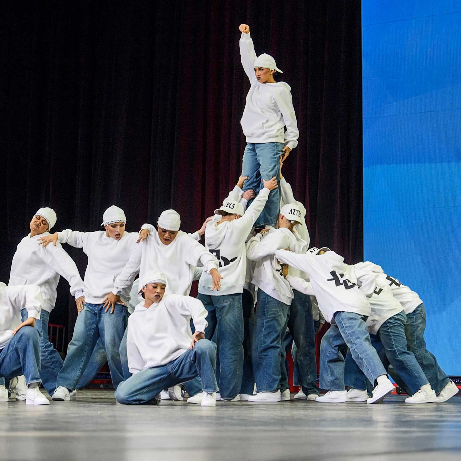 Dance Team performing on stage in hoodies 