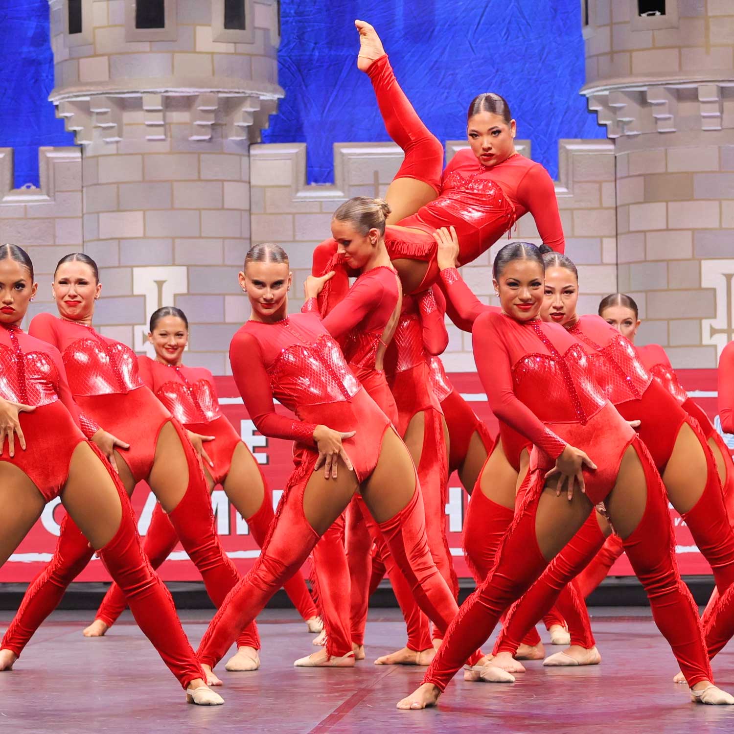 Dance Team performing on stage in red outfits