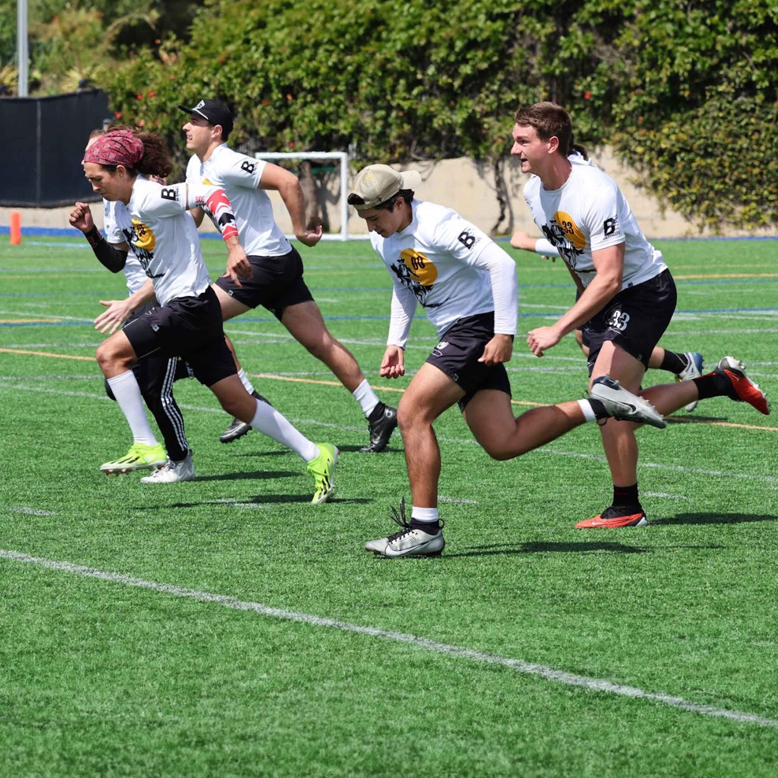 SDSU Men's Ultimate members running onto a field for a game