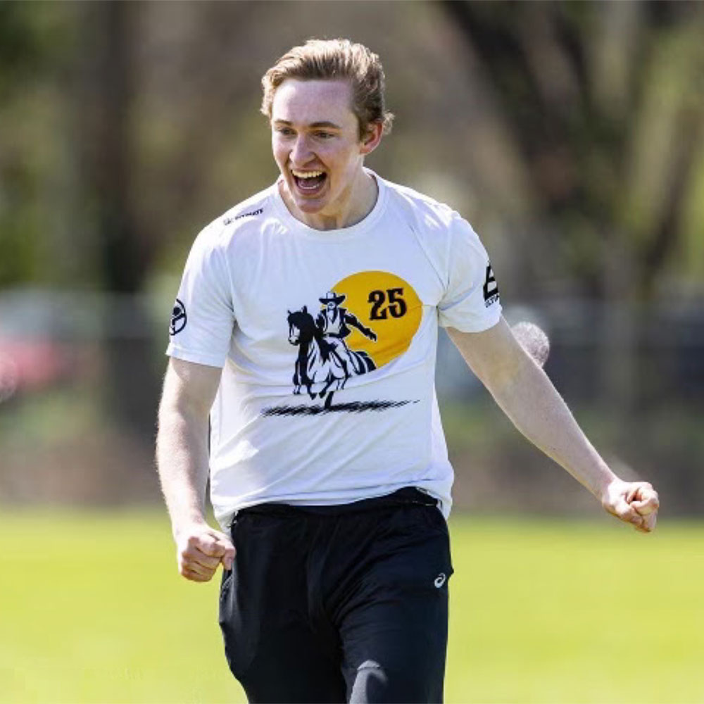 Excited SDSU Men's Ultimate club member walking on the field during a game