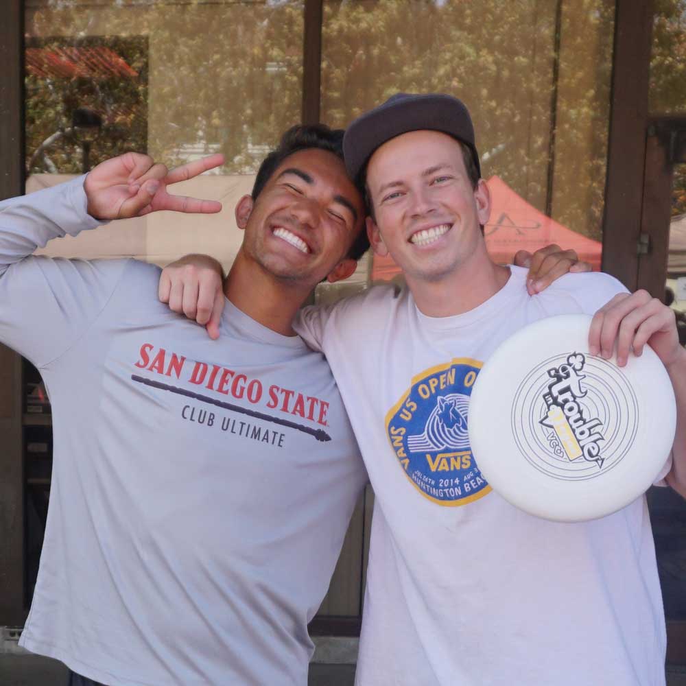 Two smiling men's ultimate frisbee at a recruiting event
