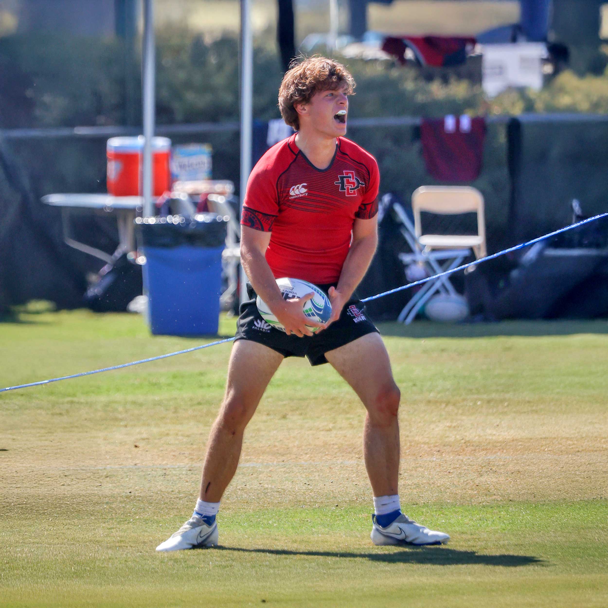 Men's Rugby player on the field, having just caught the ball