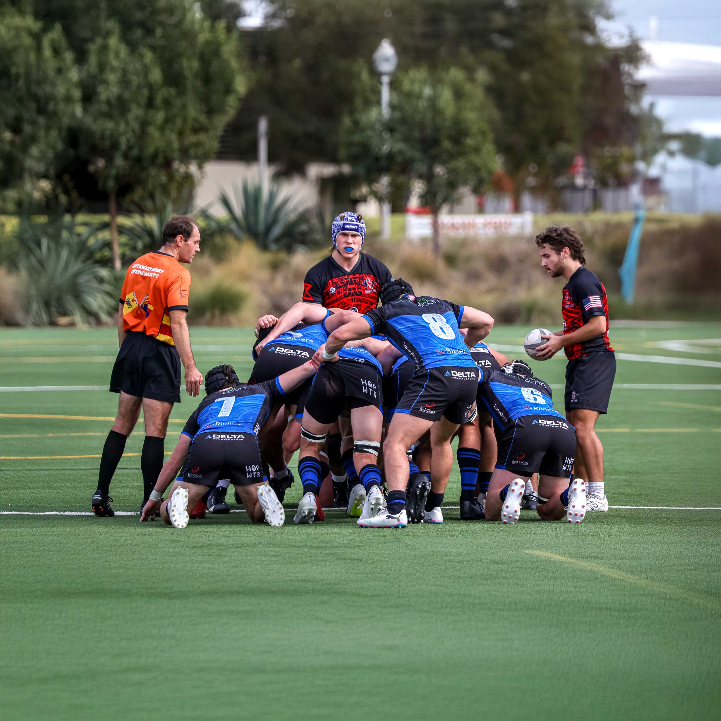 Men's Rugby game play about to start - group of players in a huddle