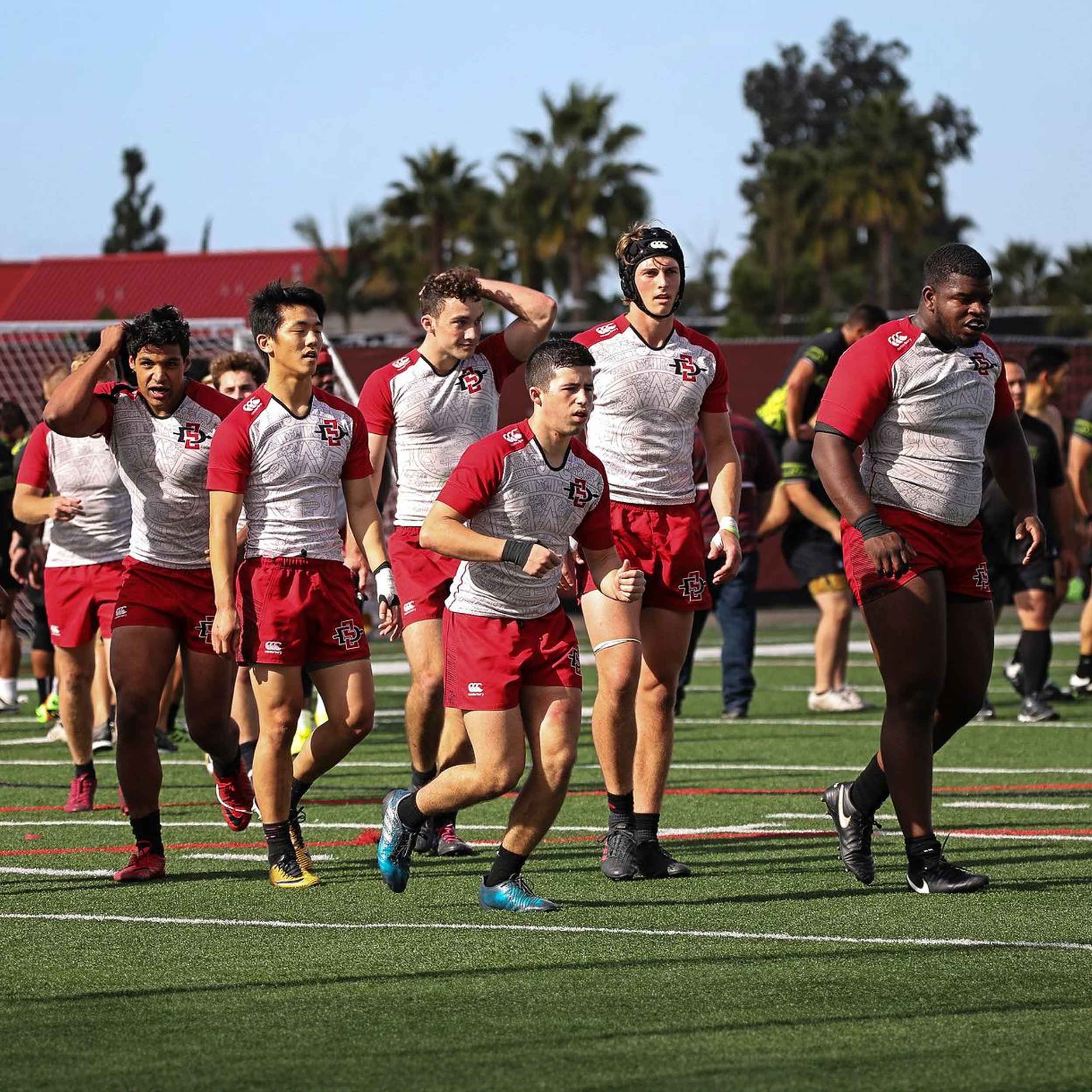 Men's Rugby players walking across the field