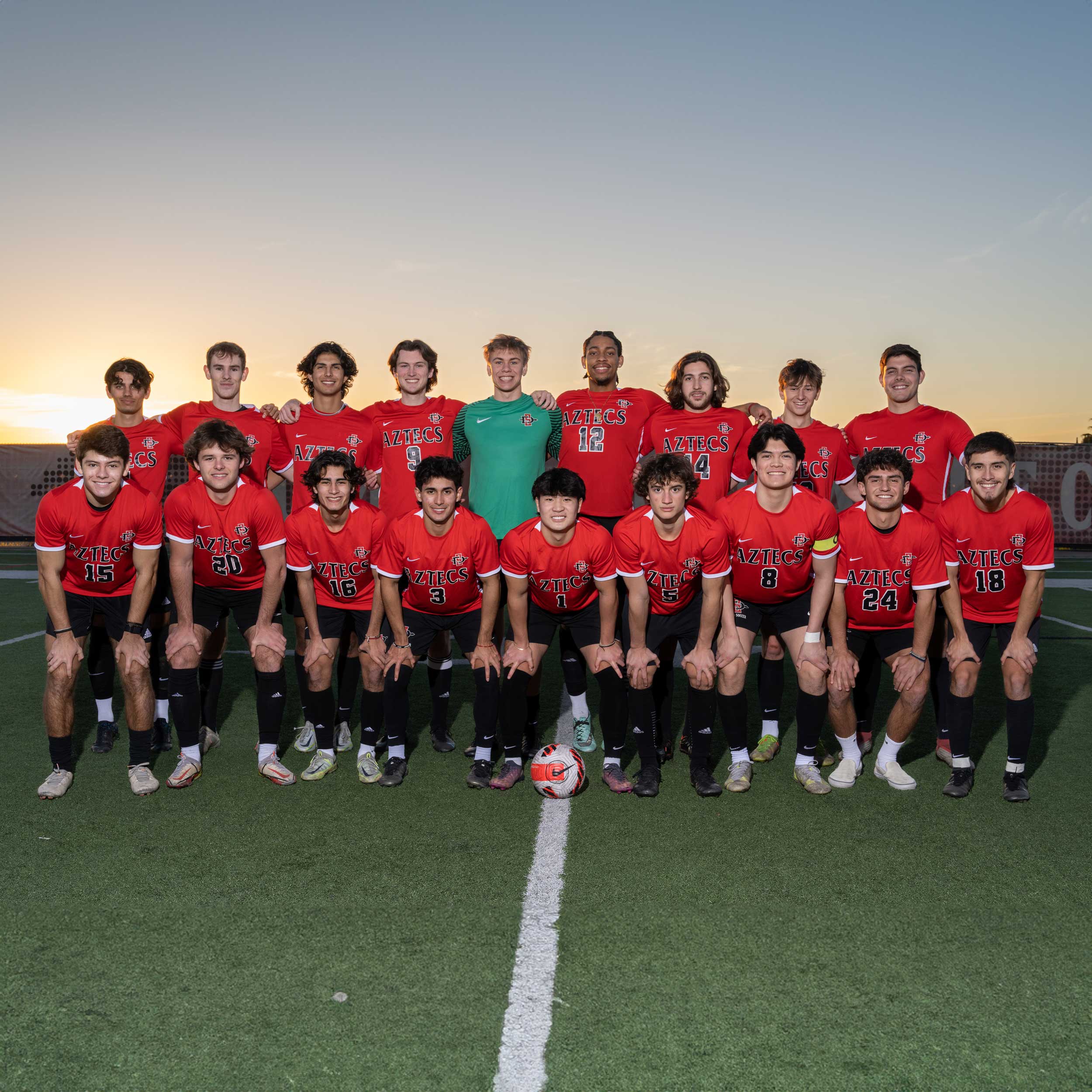 Group photo of the men's soccer club team on the soccer field