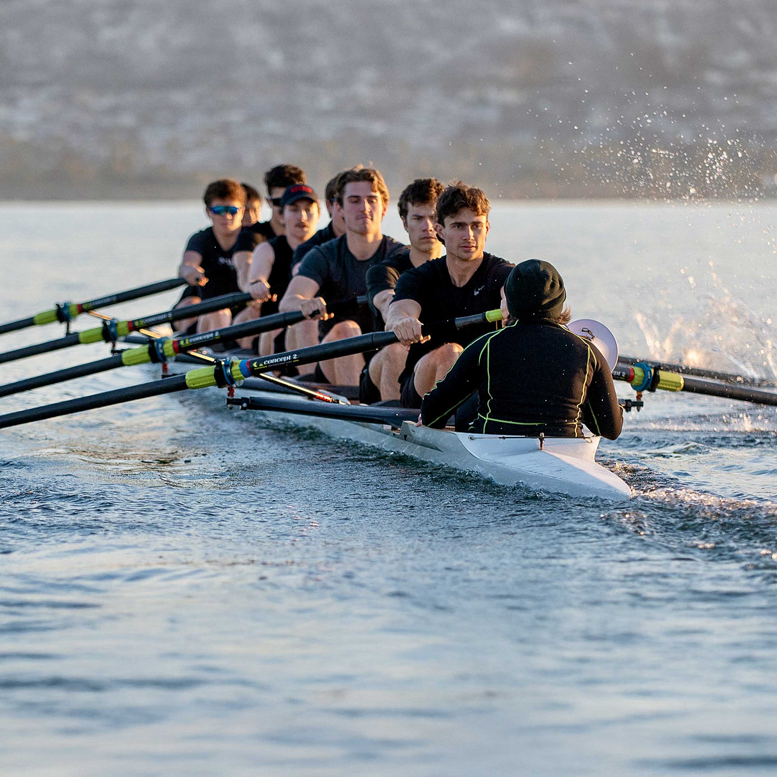 Team members in a rowing boat on water