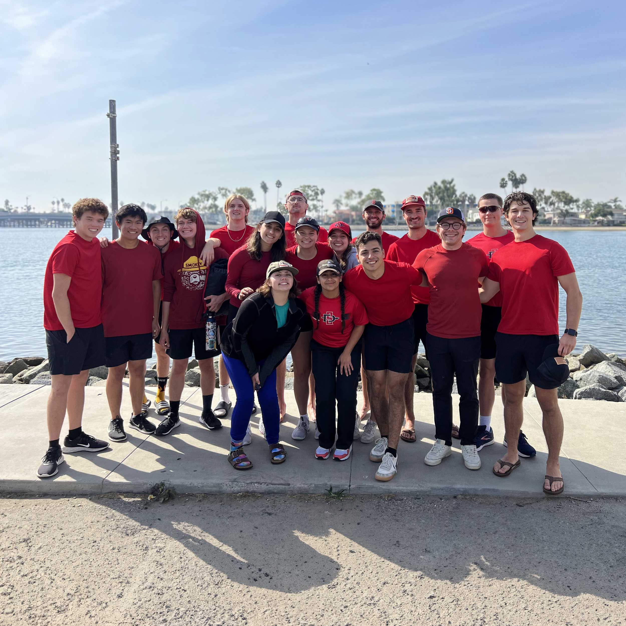 Group photo of the Aztec Rowing team members on the dock