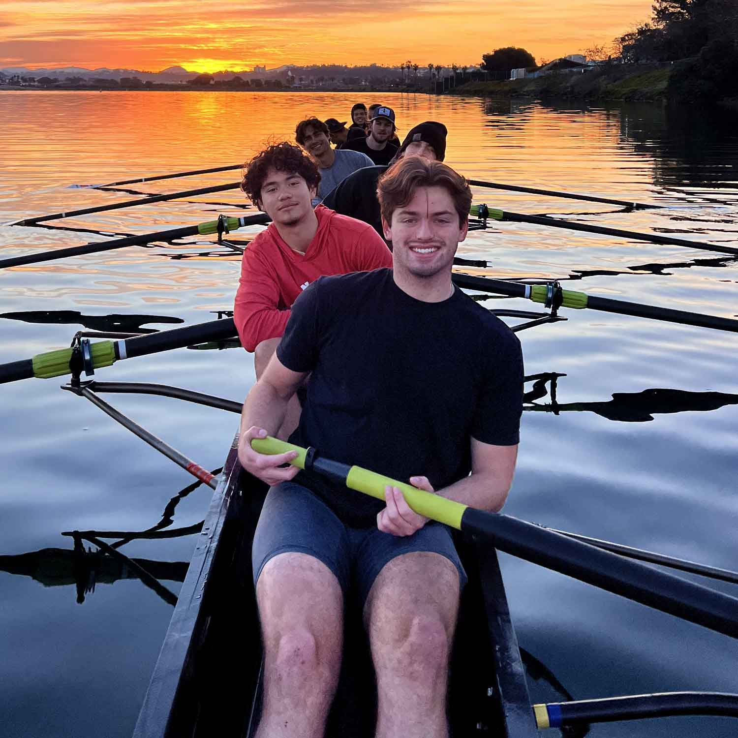 A row of oars lying on the ground, ready for action.