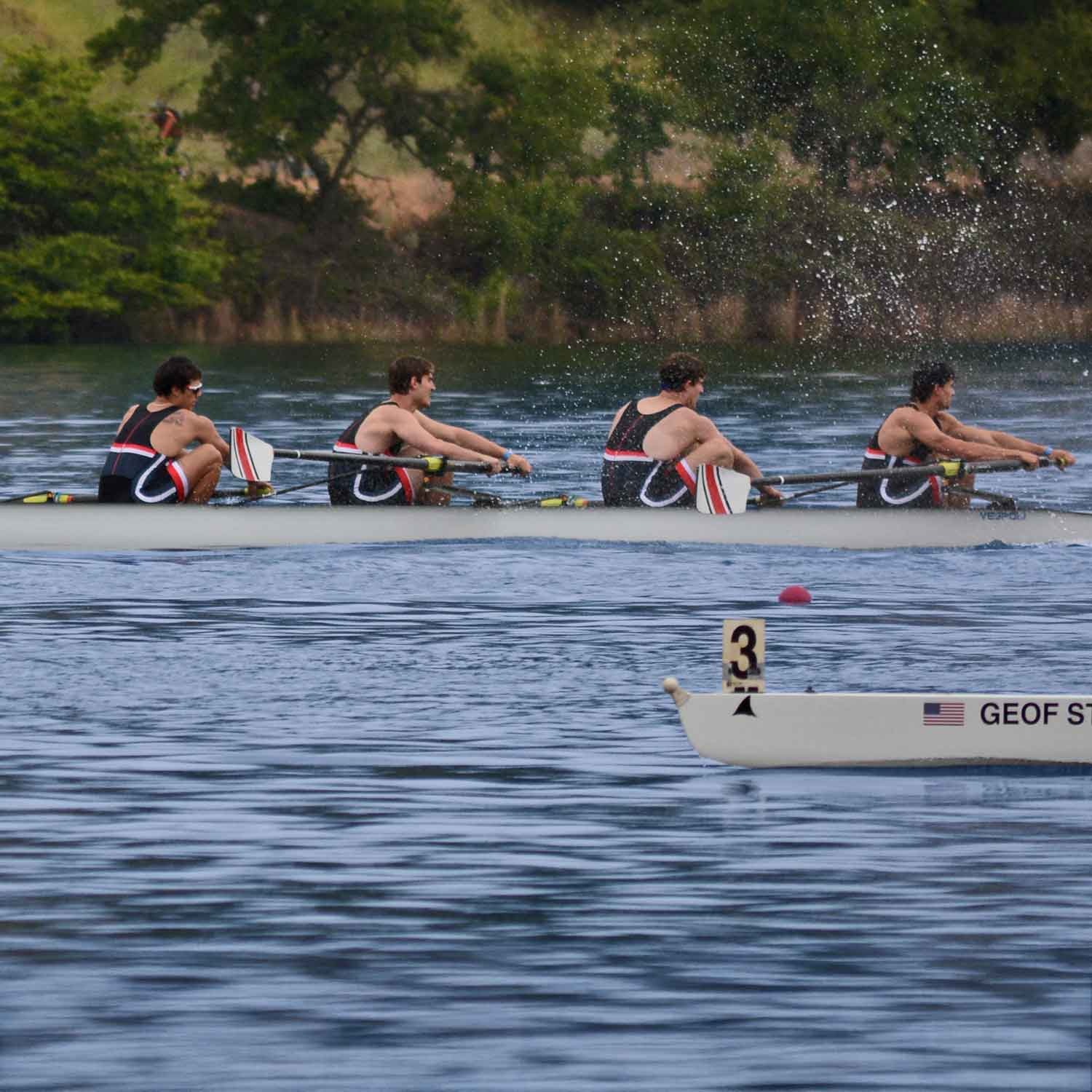 Team of rowers lifting boat onto dock before practice.