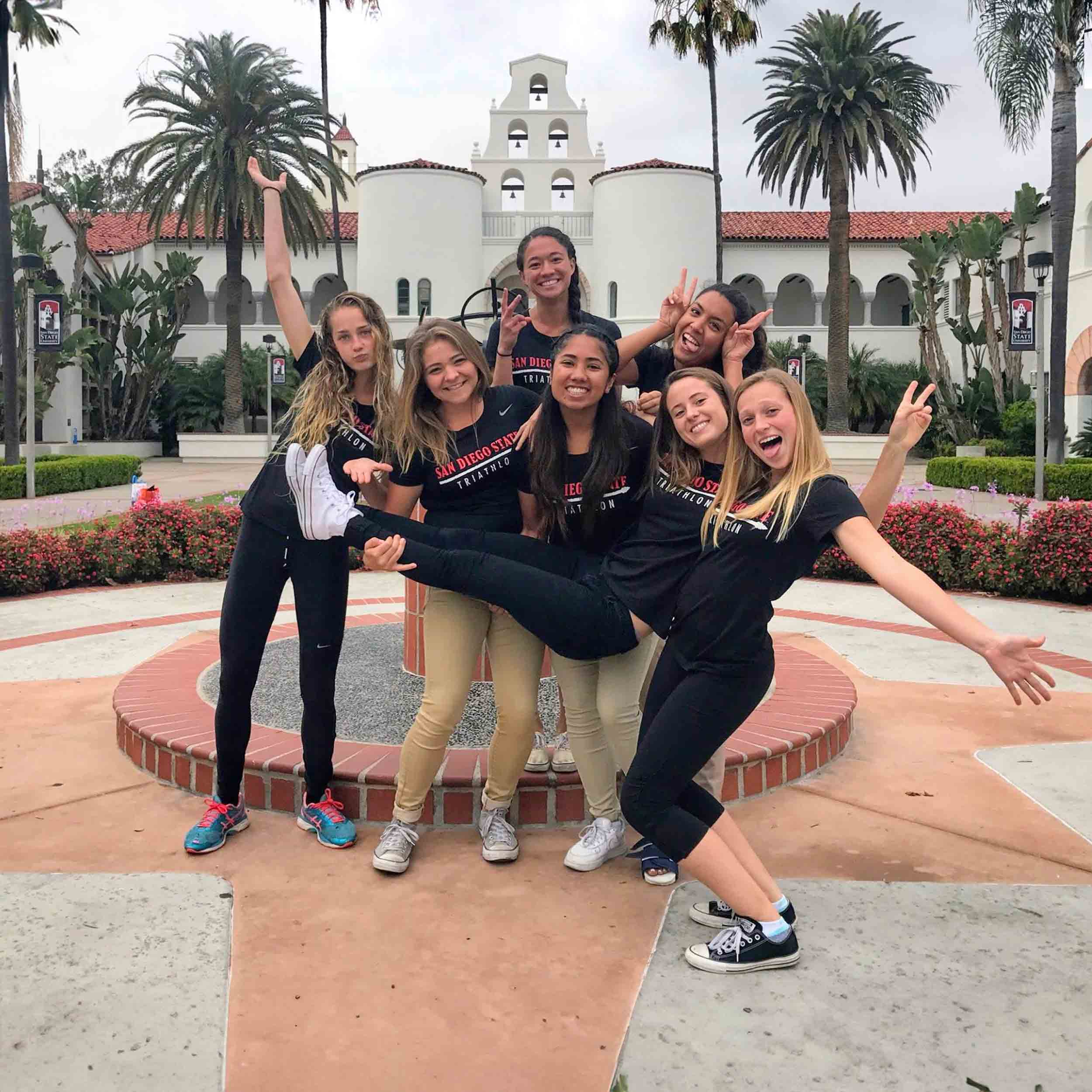 Smiling group of SDSU team members in front of Hepner Hall