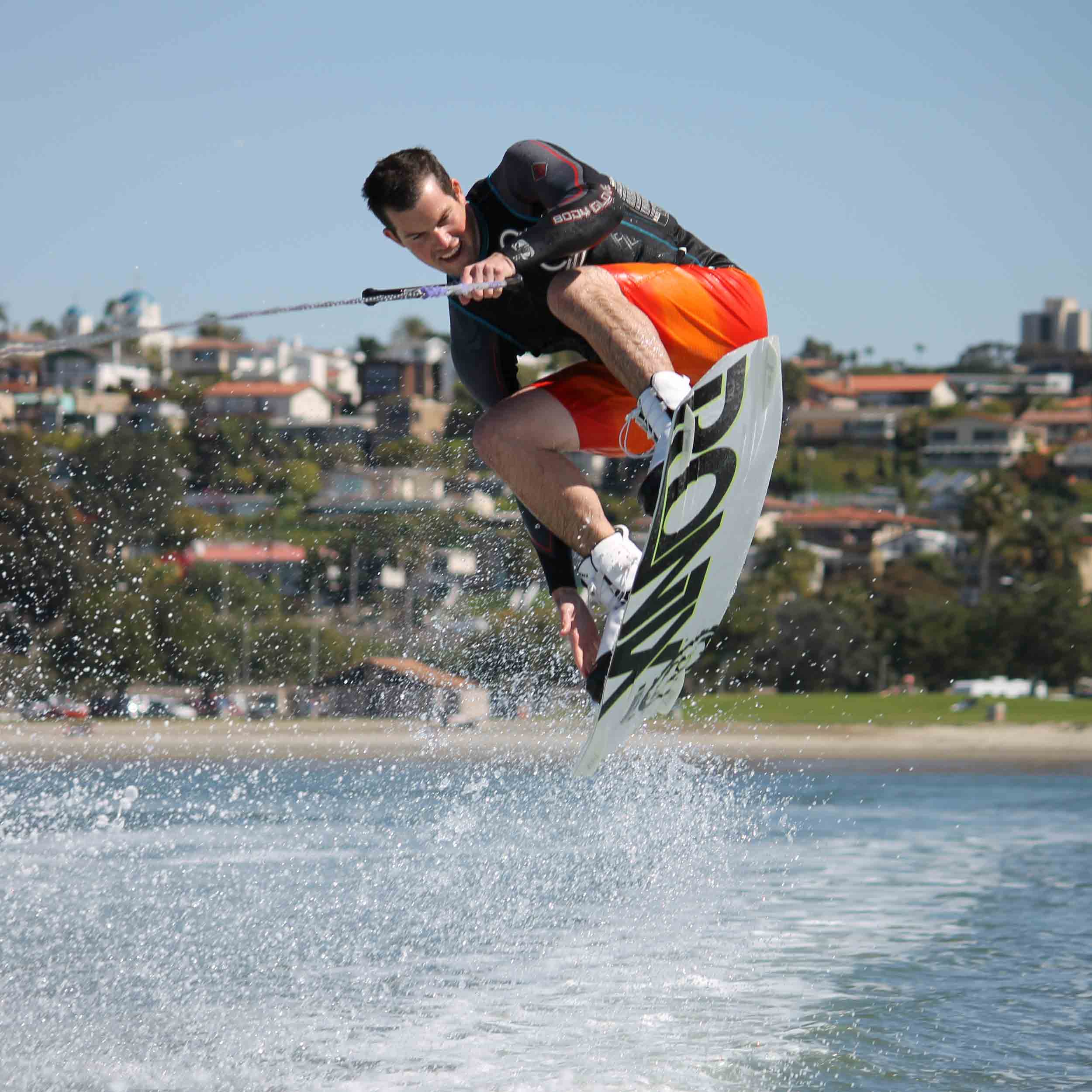 Ski and Snowboard team member making a jump on wakeboard