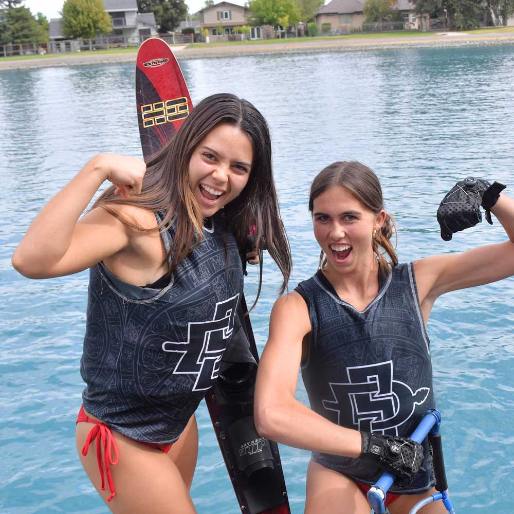 Two smiling waterski and wakesports club members making strong man poses