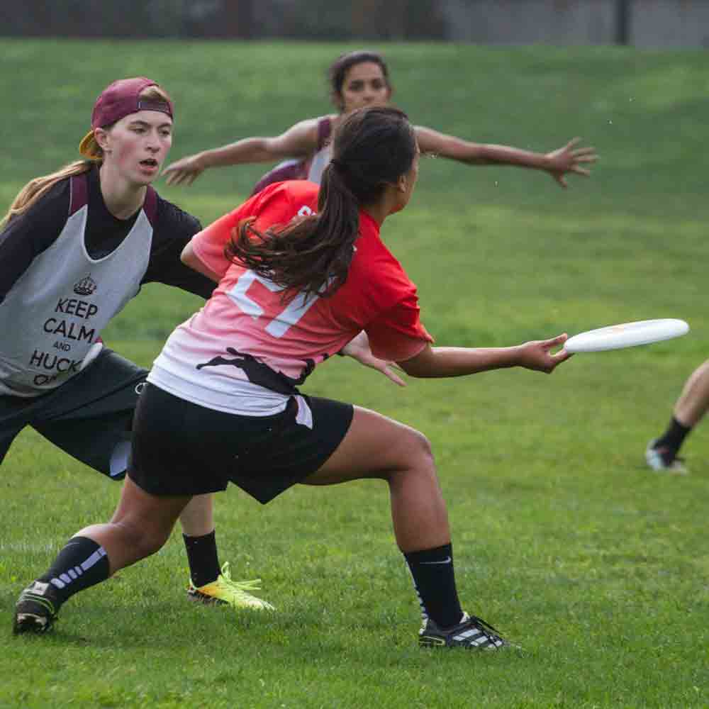 SDSU Women's ultimate frisbee member getting ready to throw a frisbee during a game