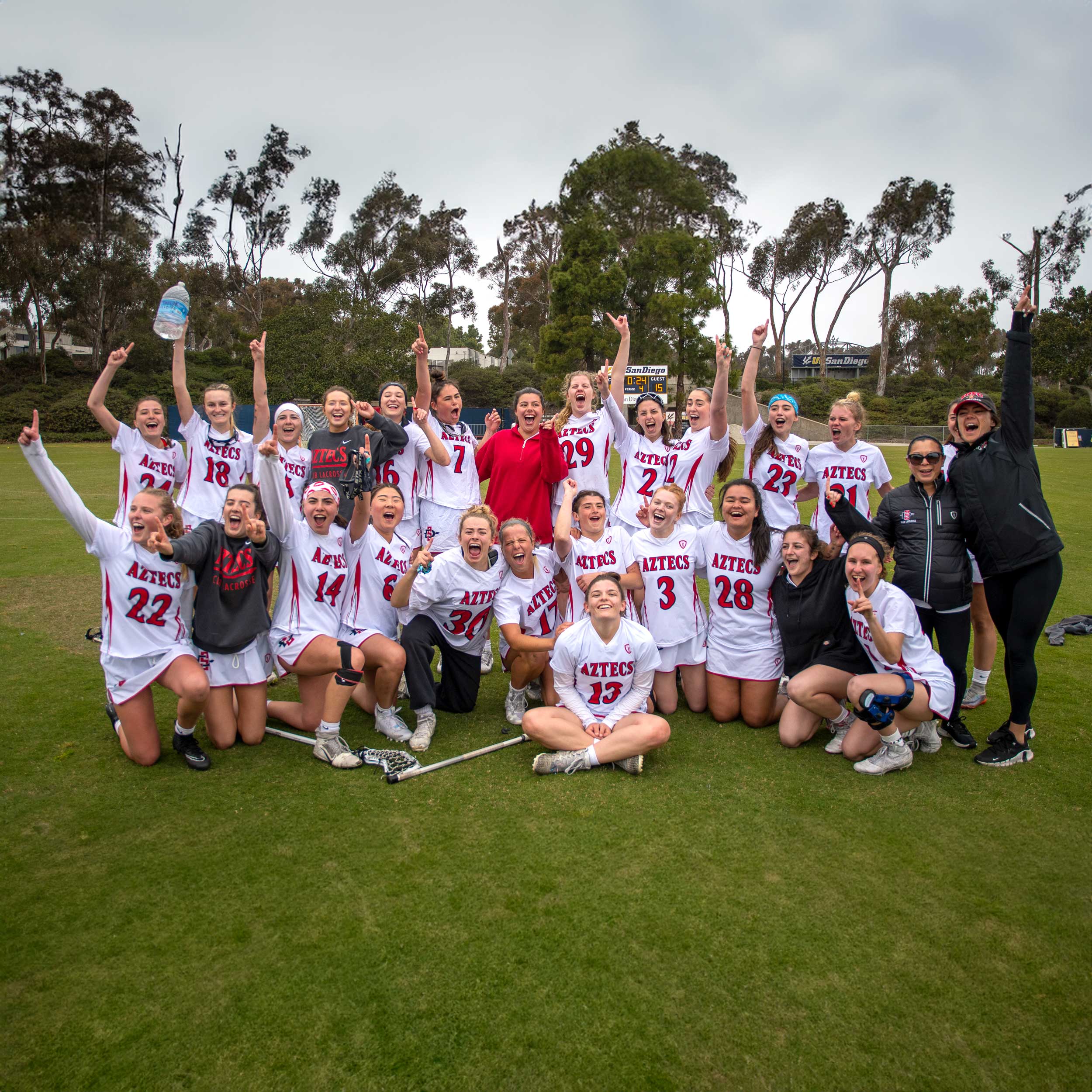 Group photo of the Women's Lacrosse team members on the field