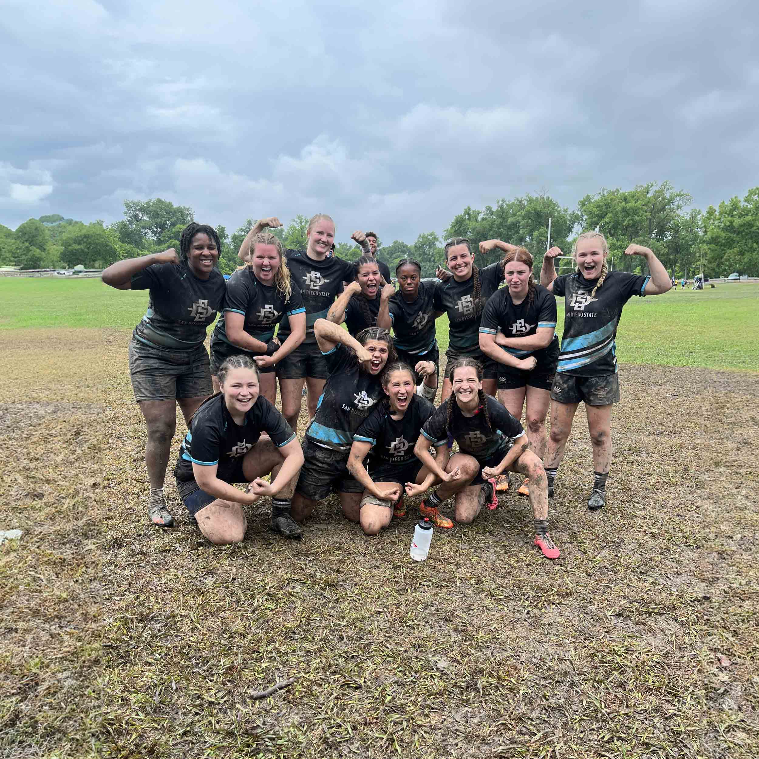 Women's Rugby showing off their arm muscles - team group photo