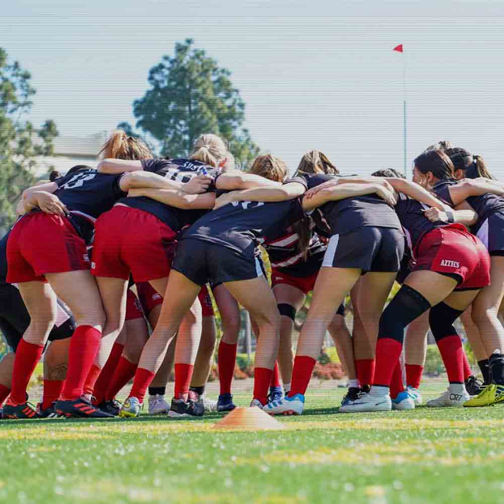 SDSU women's rugby players in a huddle during a practice
