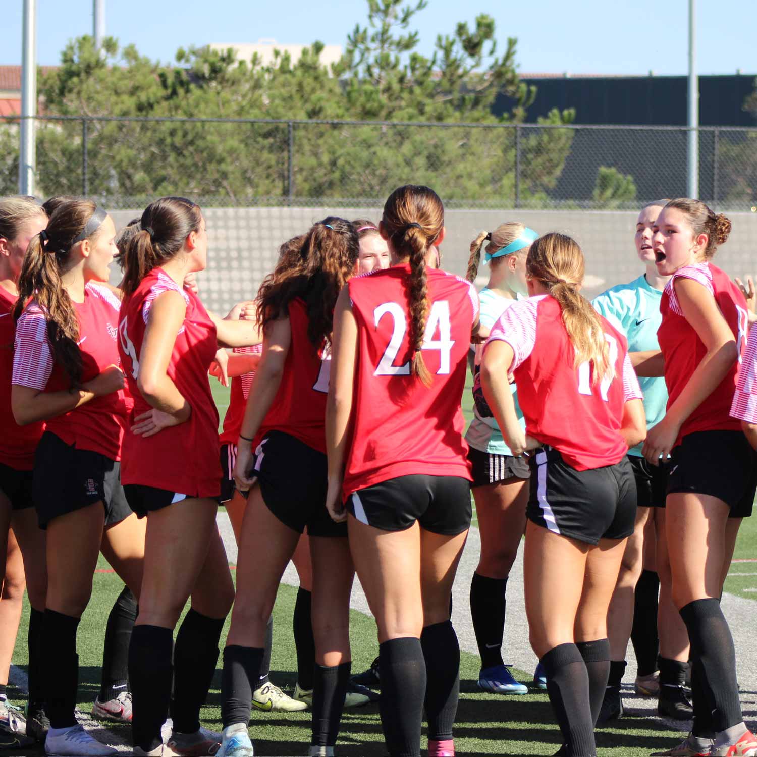 Women's Soccer members in a huddle