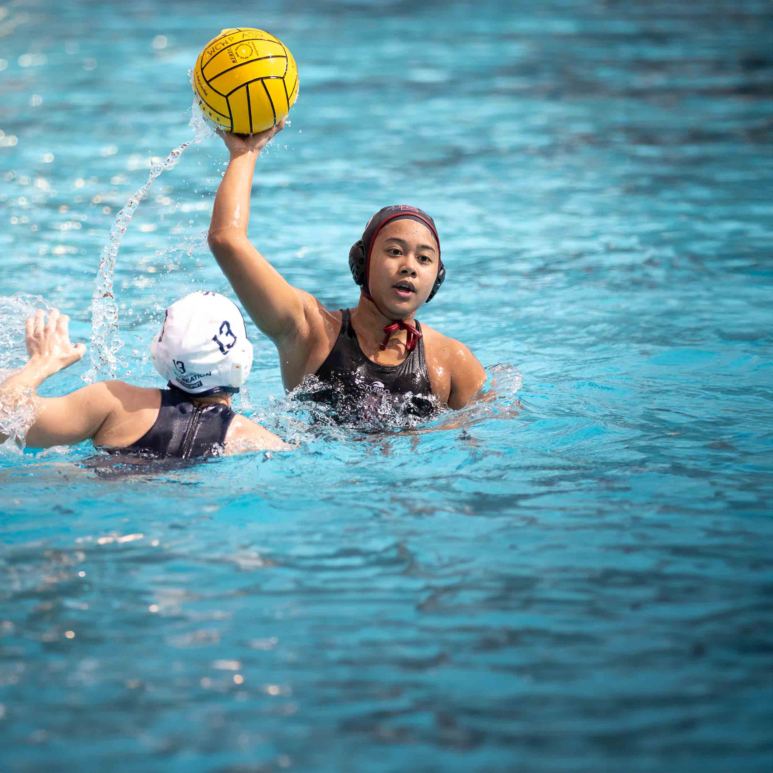 Women's Water Polo game - player throwing the ball