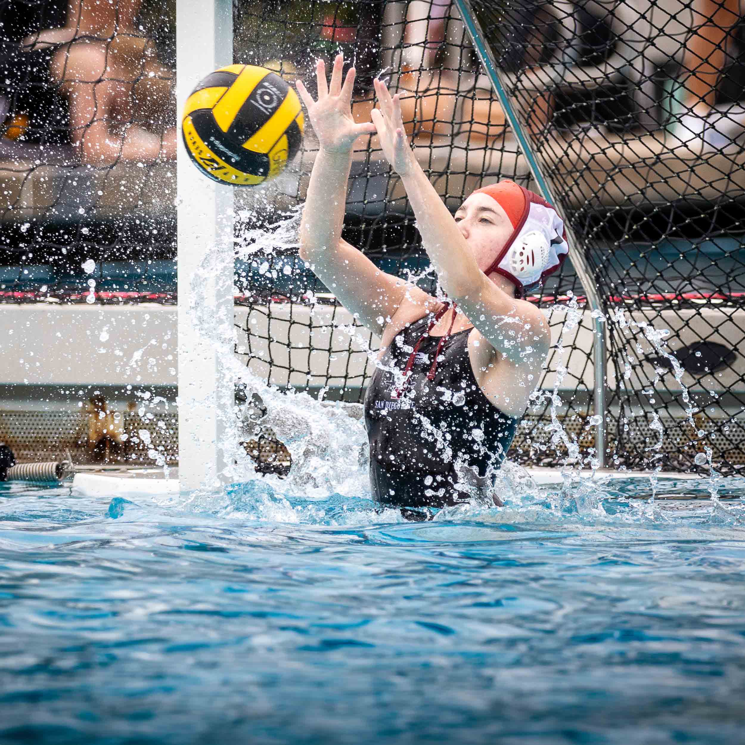 Women's Water Polo goally keeping ball from goin in